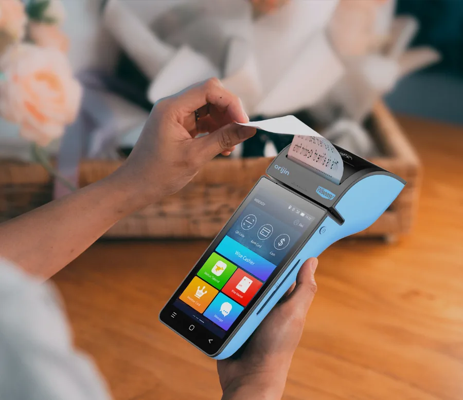 Orijin EDC terminal printing a receipt at a counter